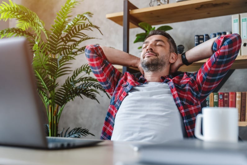Man relaxing in front of computer
