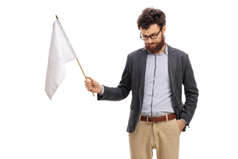 Sad man waving white flag