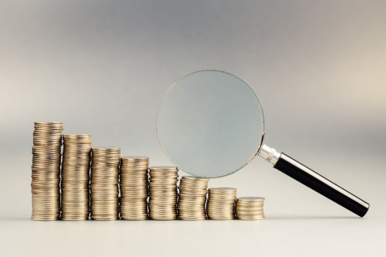Magnifying glass with coins