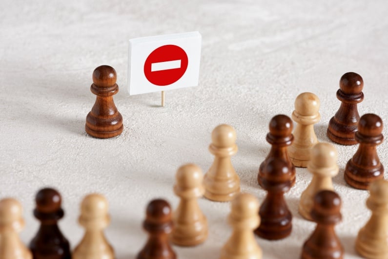 Chess pieces with stop sign