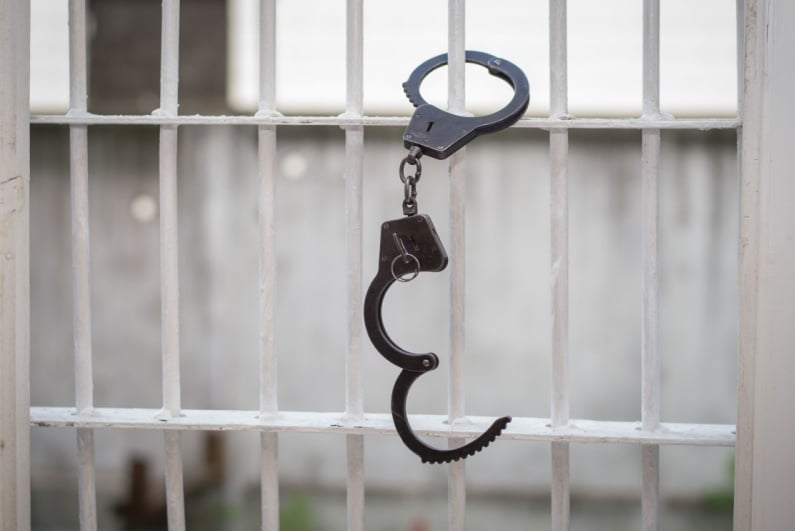 Handcuffs on jail cell