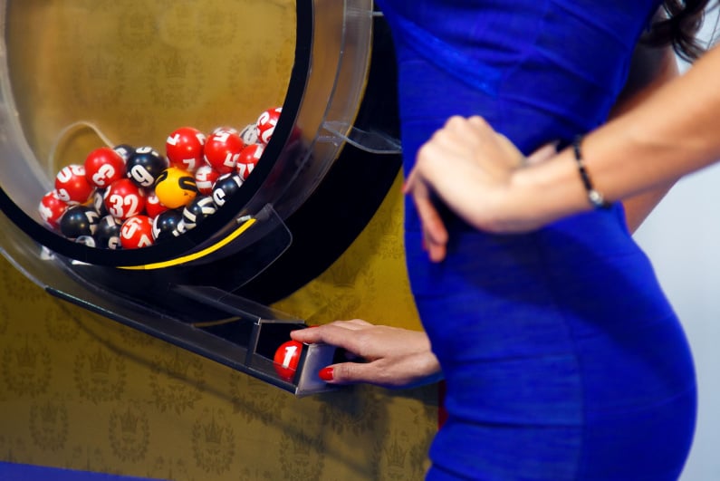 Woman drawing lottery balls