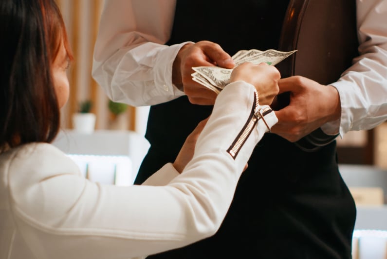 Woman paying waiter
