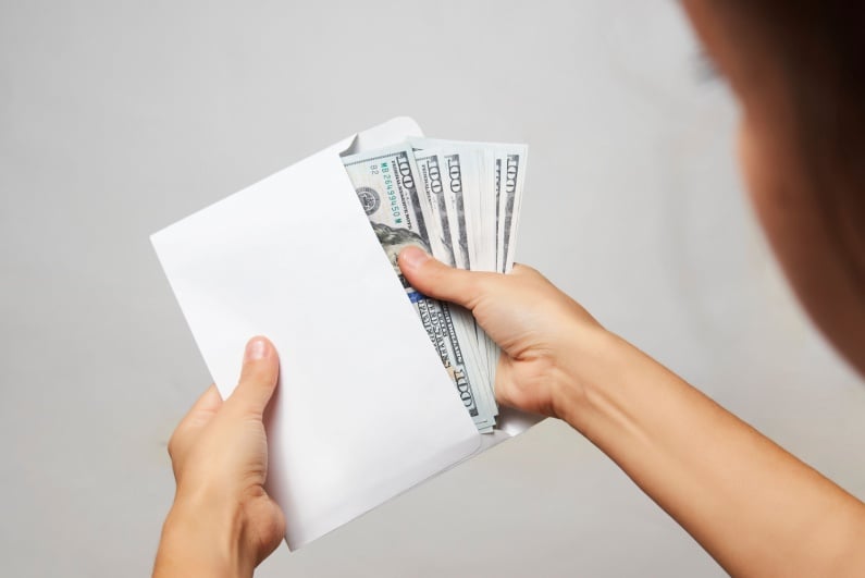 Woman taking money from envelope