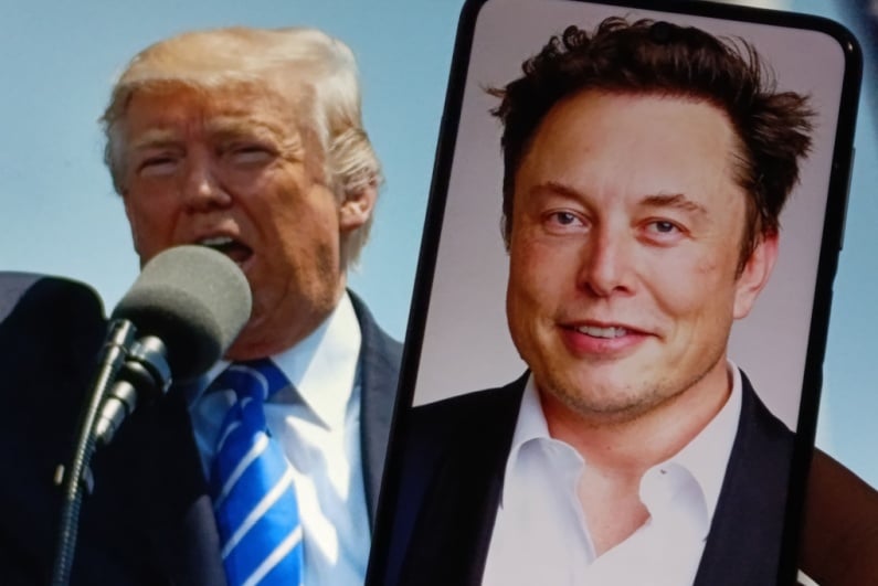 Donald Trump at a rally with a picture of Elon Musk on phone