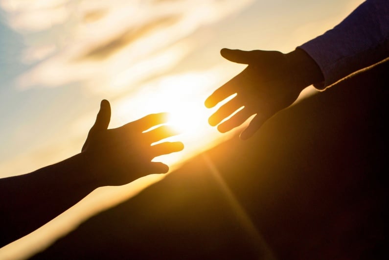 Hands reaching out to each other