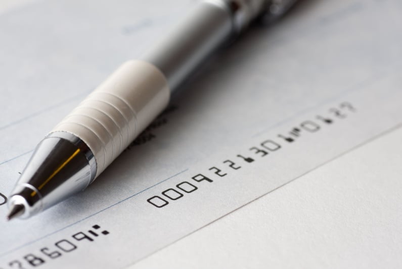 Closeup of check and pen