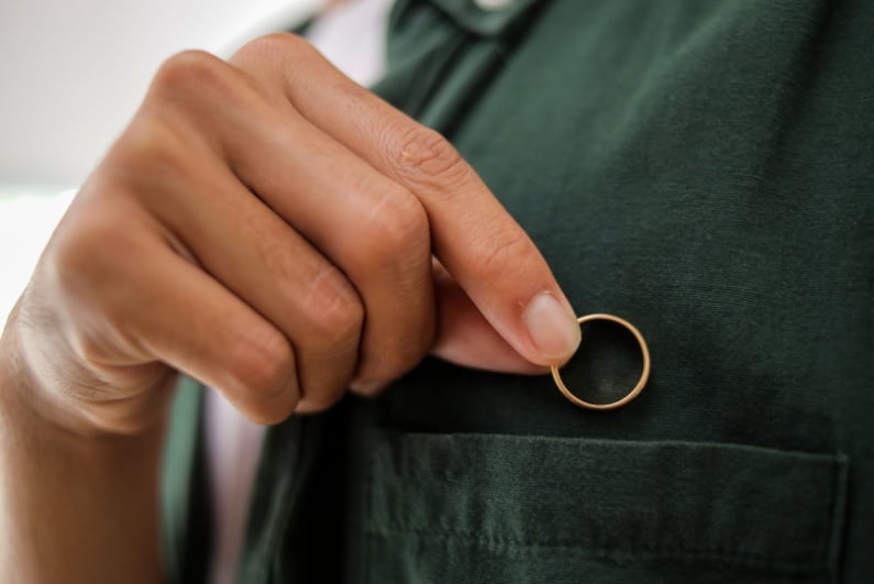 Person putting ring in pocket