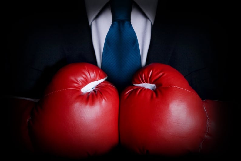 Man in suit with boxing gloves