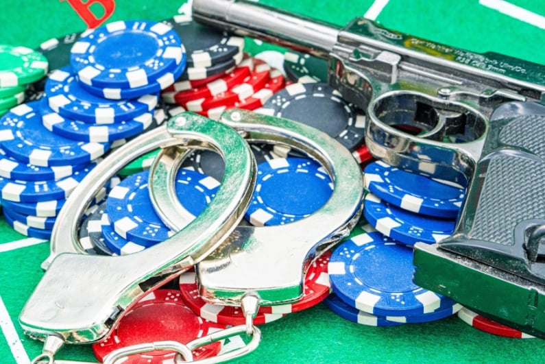 Handcuffs, gun, poker chips