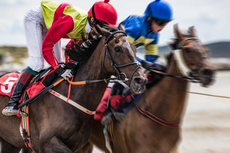 Jockeys racing on horses