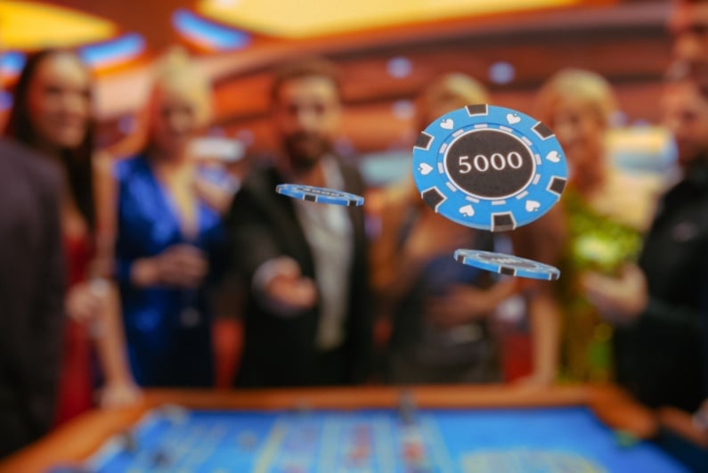Person throwing poker chips