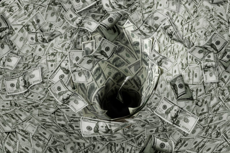 $100 bills spiraling down a hole