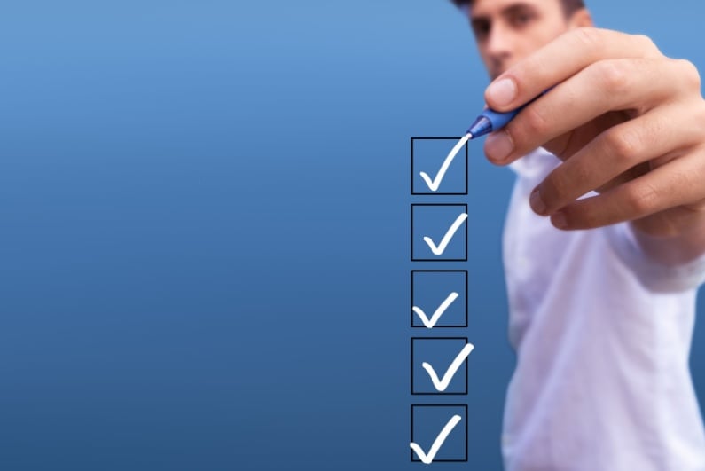 Man checking off five boxes