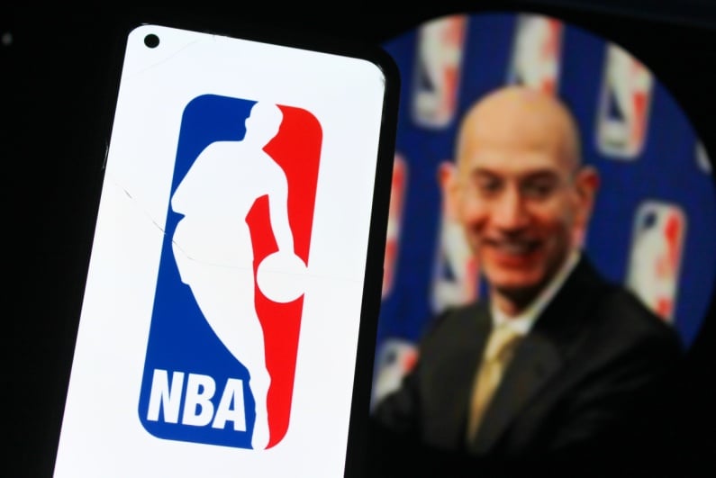 NBA logo on phone with Adam Silver in background