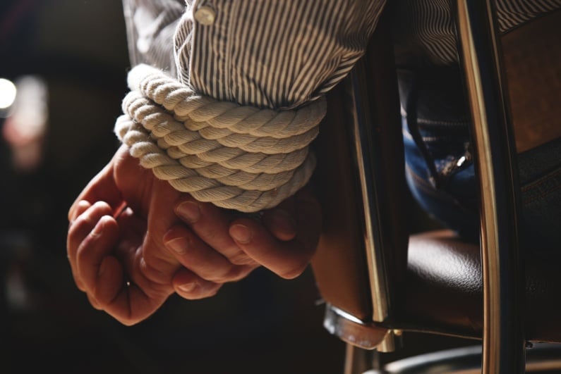 Person tied to chair