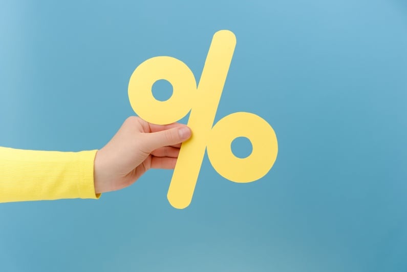 Person holding percent sign
