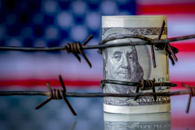 US cash behind barbed wire