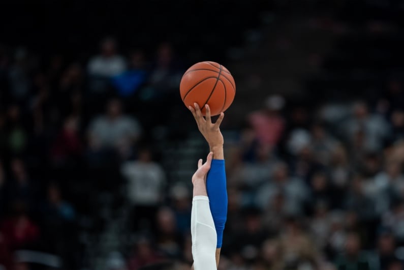 Hands reaching for basketball