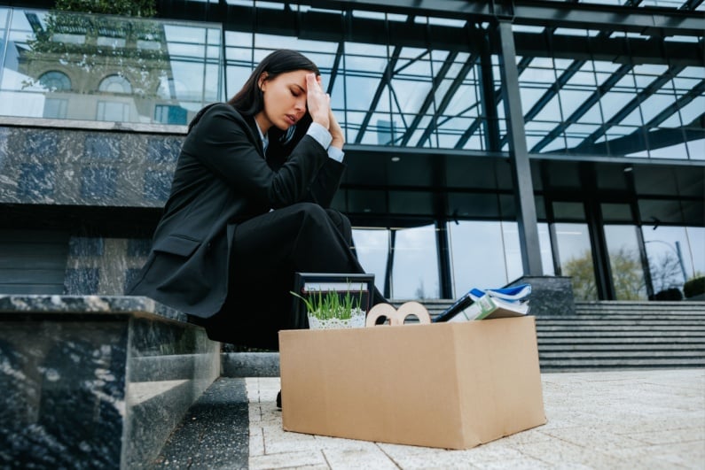 Woman losing job with box of stuff