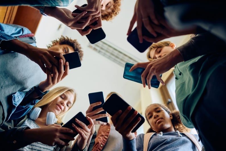 Teenagers looking at their phones