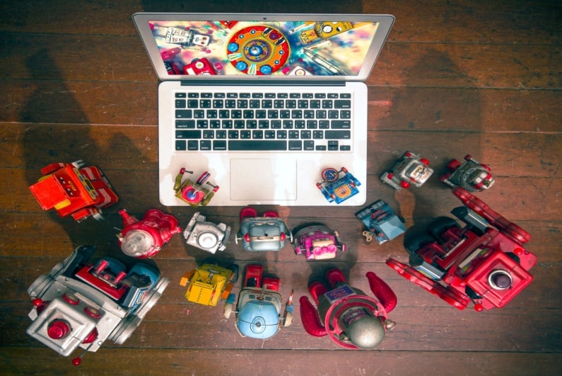Toy robots watching movie on laptop