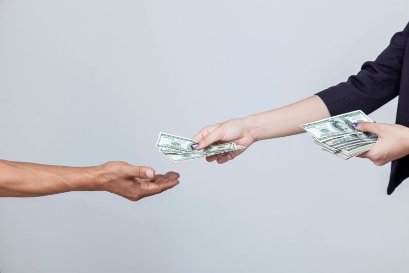 Woman handing person cash