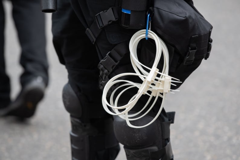 Zip ties hanging from police belt