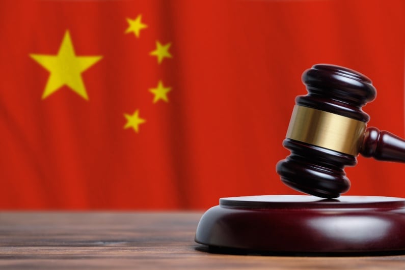 Gavel in front of Chinese flag