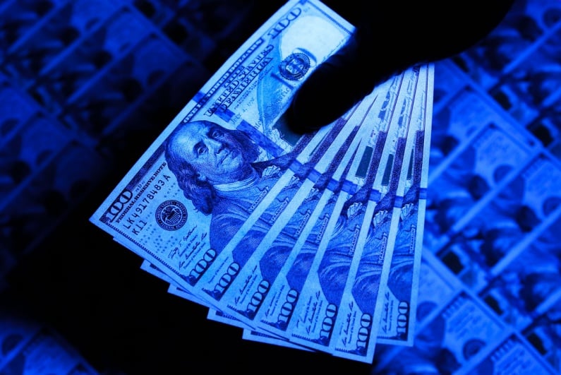 Checking for counterfeit bills with UV light