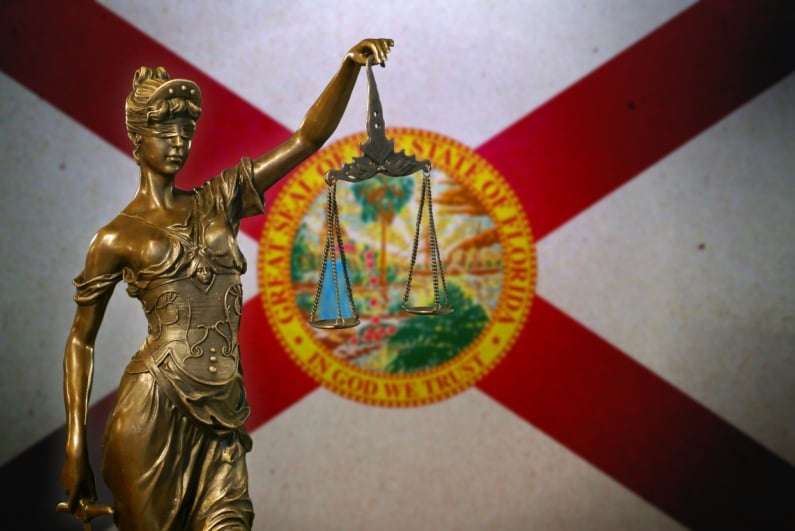 Lady Justice in front of Florida flag
