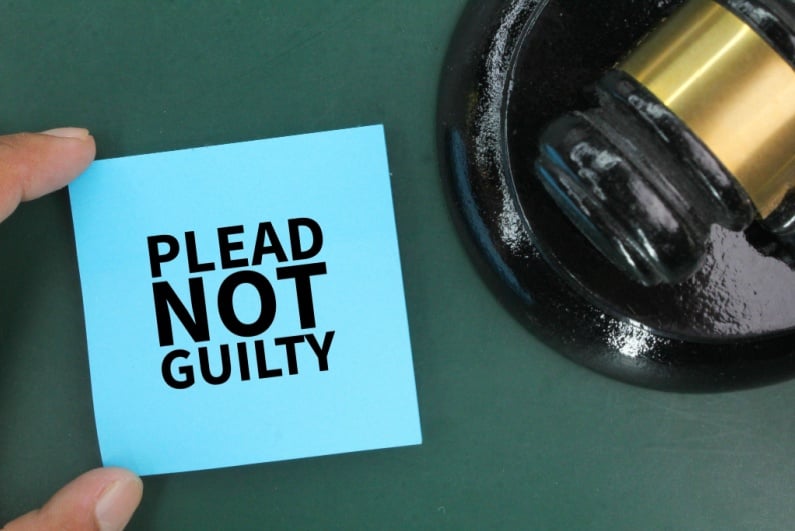Plead not guilty next to gavel
