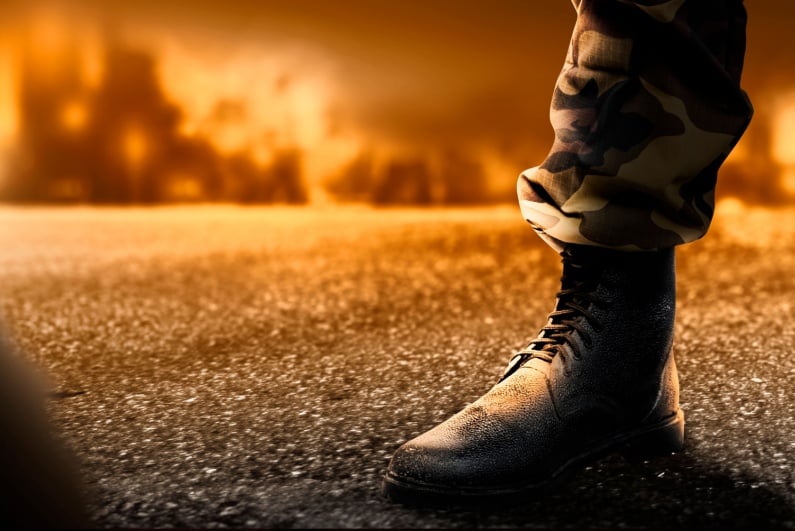 Soldier foot with fire in background