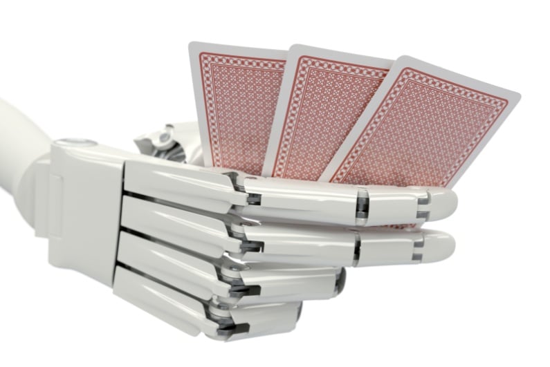 Robot hand holding playing cards