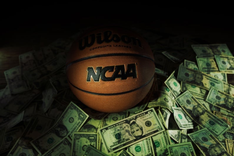 Shadowy NCAA basketball on top of cash