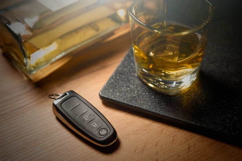Car keys next to alcoholic beverage