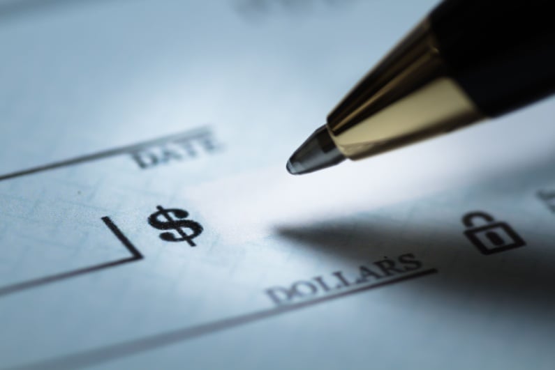 Closeup of pen writing a check
