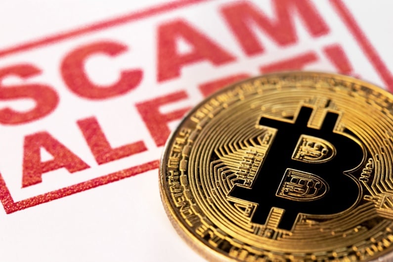Bitcoin and Scam Alert sign