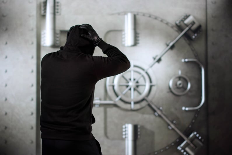 Frustrated robber in front of vault