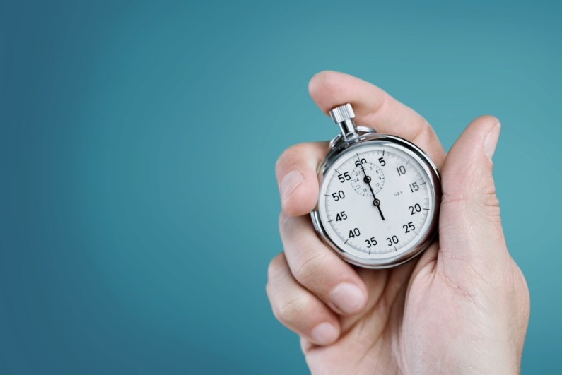 Man holding analog stopwatch