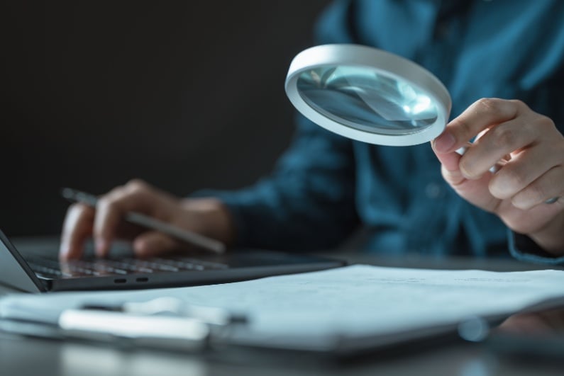 Person using magnifying glass