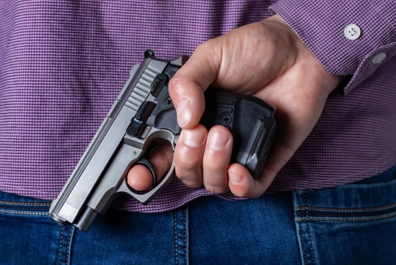 Gun behind back