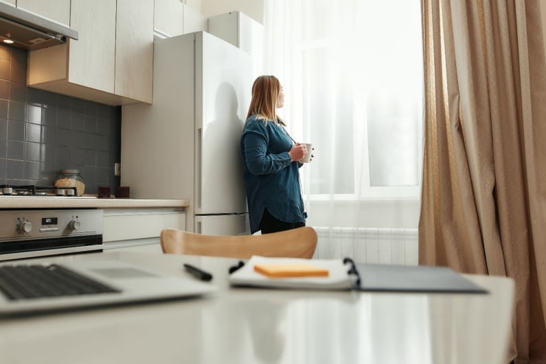 Woman taking a break and looking out the window
