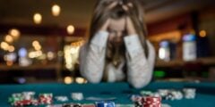 Person gambling with head in hands