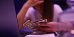 Woman looking sad with money