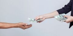 Woman handing person cash