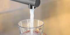 Person filling glass of tap water