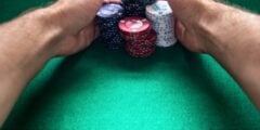 Man pulling in stacks of poker chips
