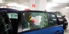 Broken car window in parking garage